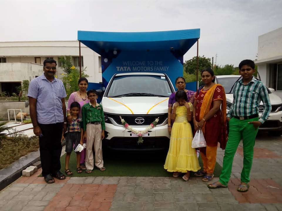Family receiving new car with car finance support from Car Loan Madurai